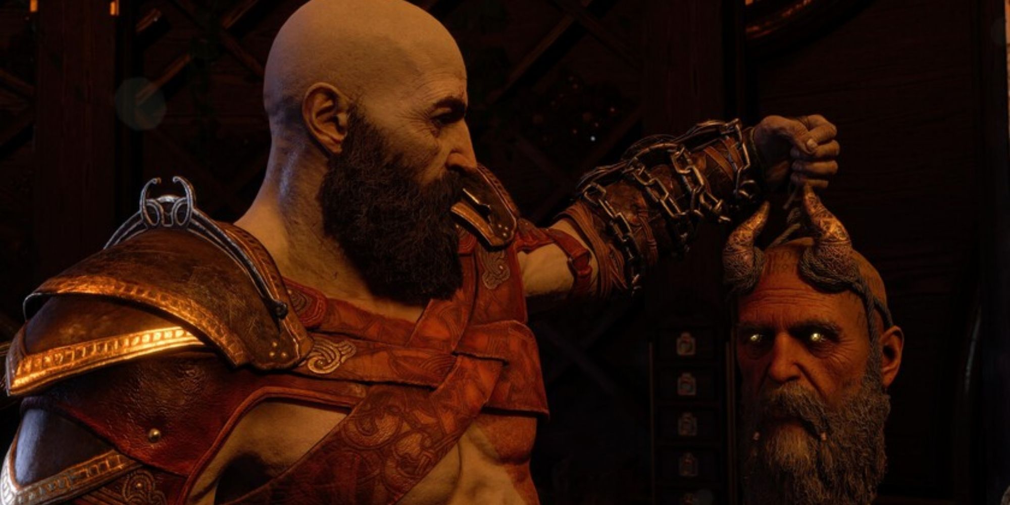 Kratos holds Mimir's head up as they have a conversation in God of War Ragnarok