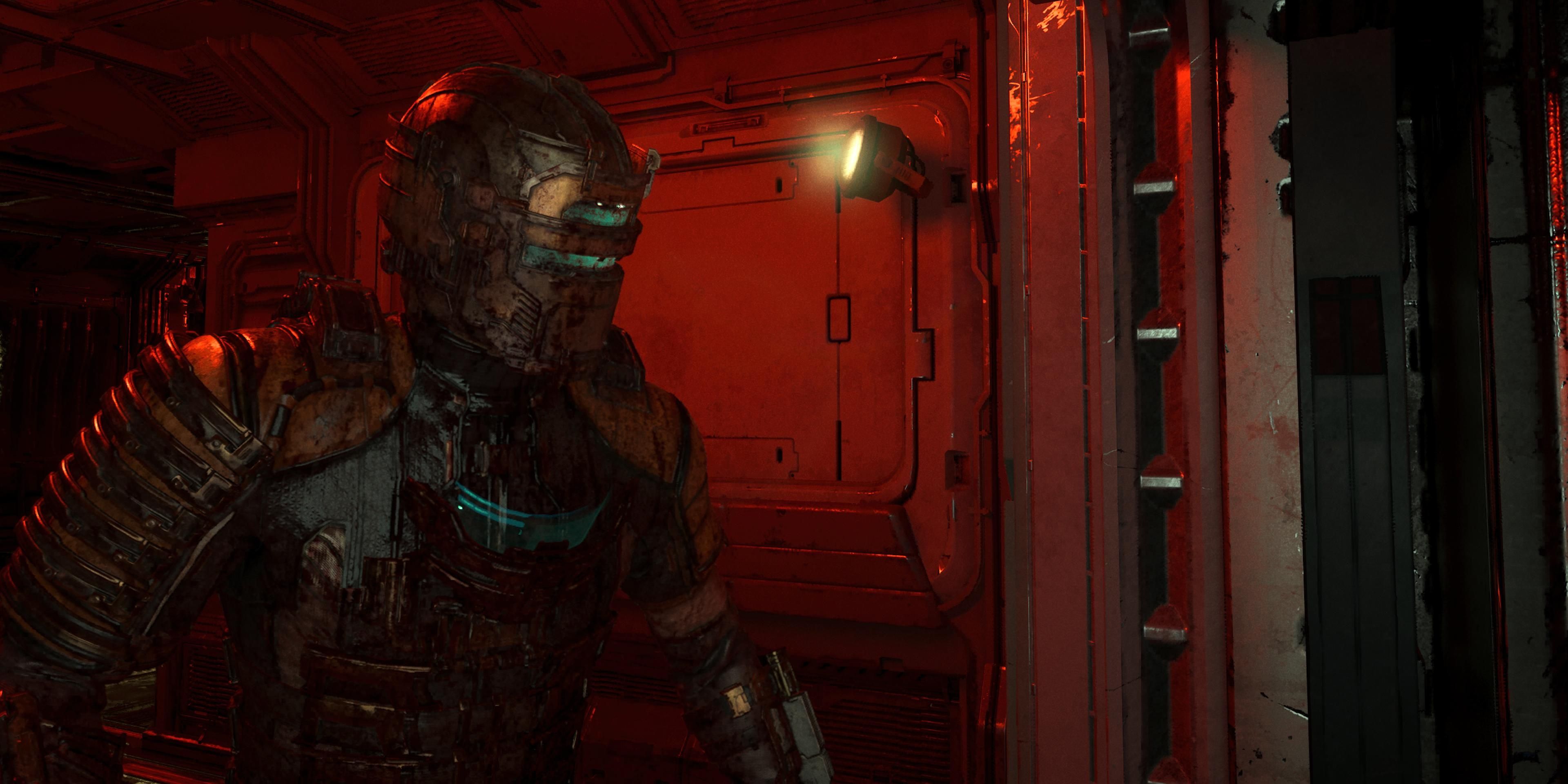 Isaac standing in the glow of a red light inside the Ishimura in Dead Space
