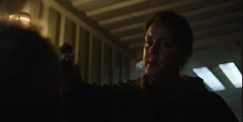 Kathleen putting as gun to someone's head in HBO's The Last of Us series