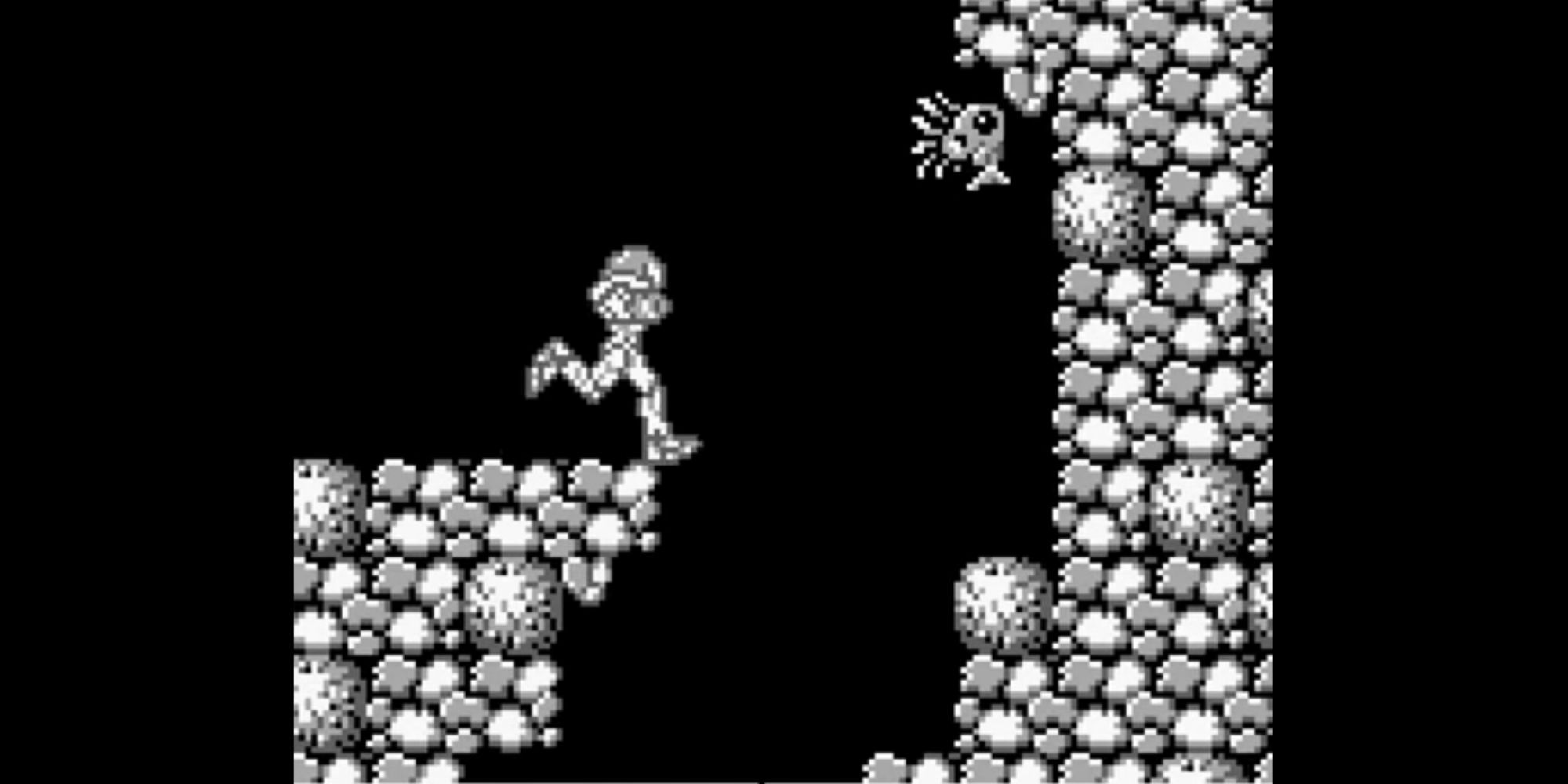 Samus runs toward a hole in the floor in Metroid 2: Return of Samus