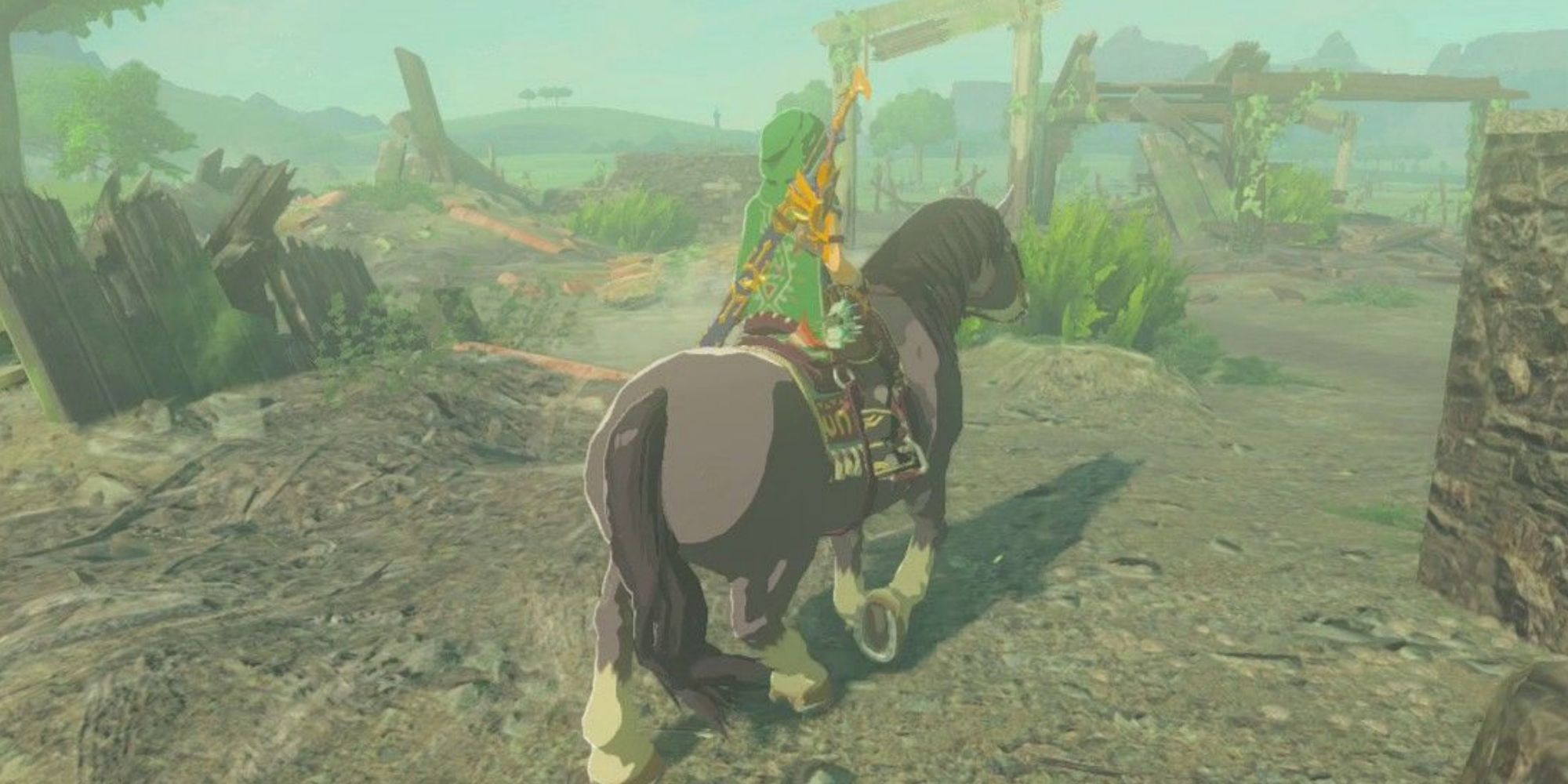 Link riding a horse through ranch ruins in Breath of the Wild.