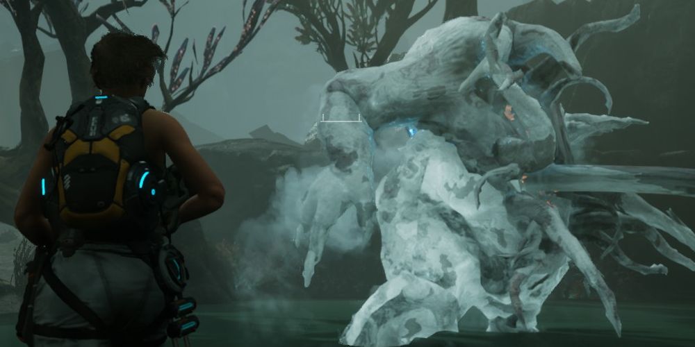kate runs around to the rear of a frozen colossus to hit its weak point