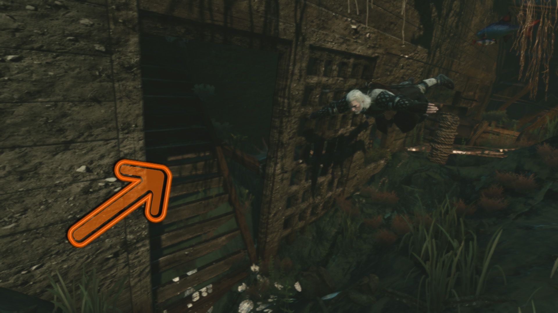 An annotated screenshot of Geralt swimming into a sunken ship with an orange arrow indicating where the entrance should be.