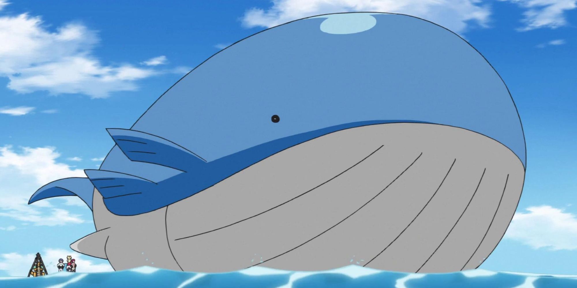 Wailord towers over Pokemon Trainers while floating in the ocean