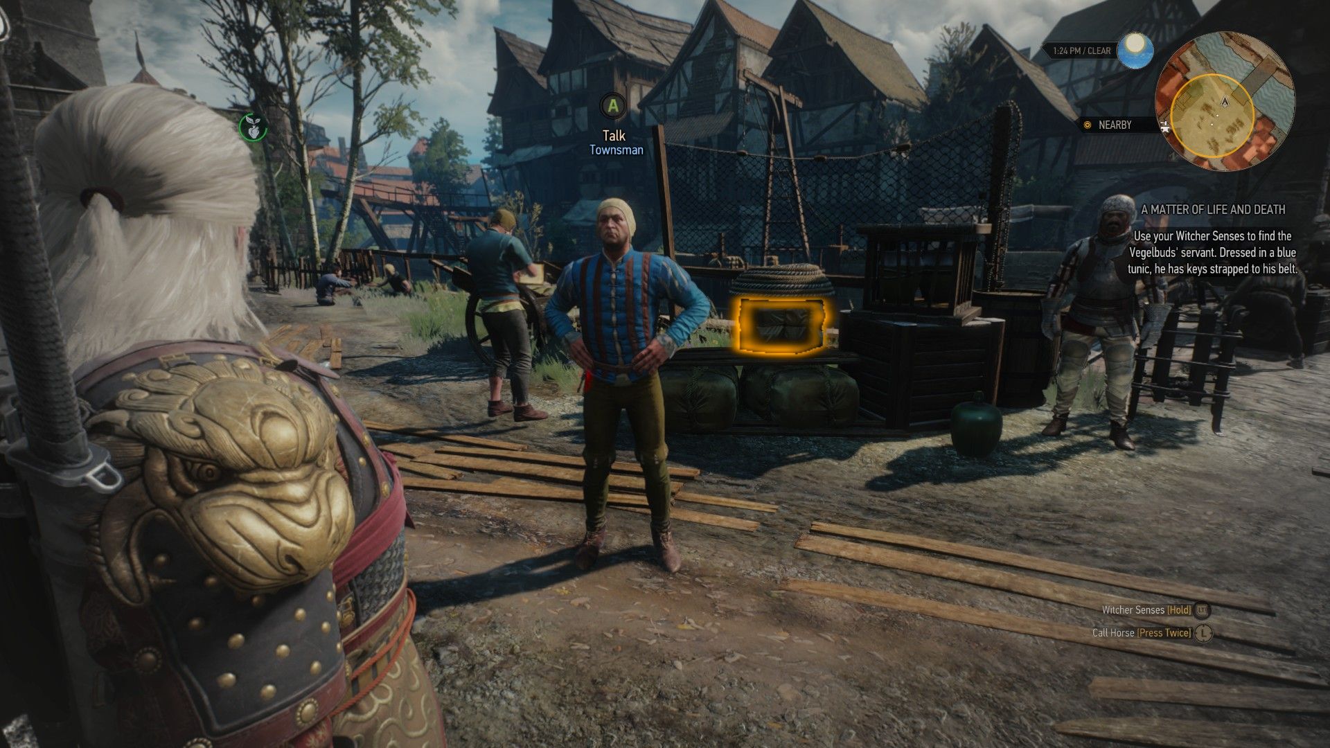 A screenshot of The Witcher 3, with a man in a blue top standing with his hands on his hips in the Novigrad Fish Market.