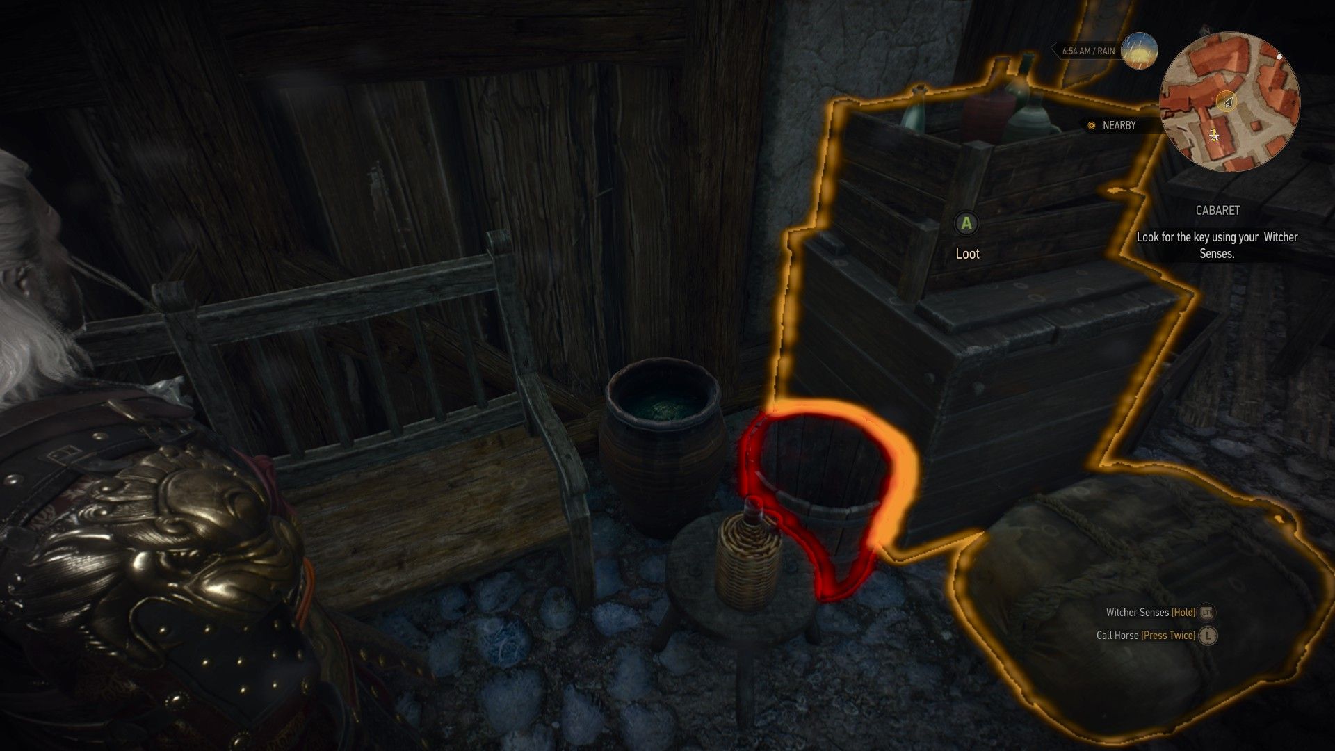 A screenshot from The Witcher 3 showing where to find a key inside a bucket.