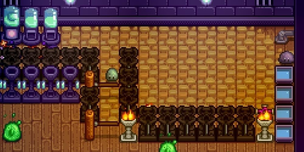 Slimes blobbing around a slime hutch in Stardew Valley the video game