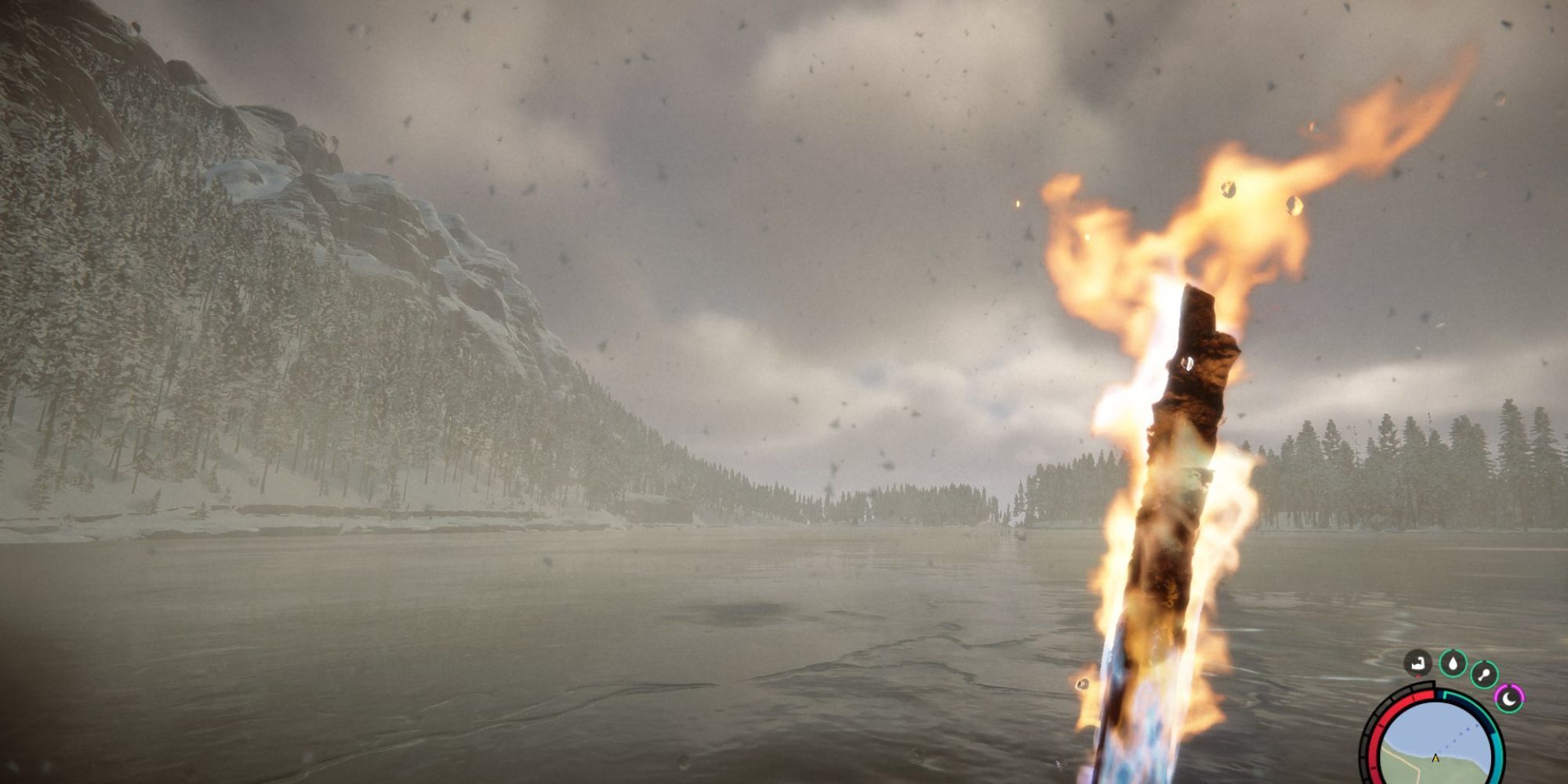 player holds a torch as snow falls down the frozen lake, with snow-covered mountains in the back