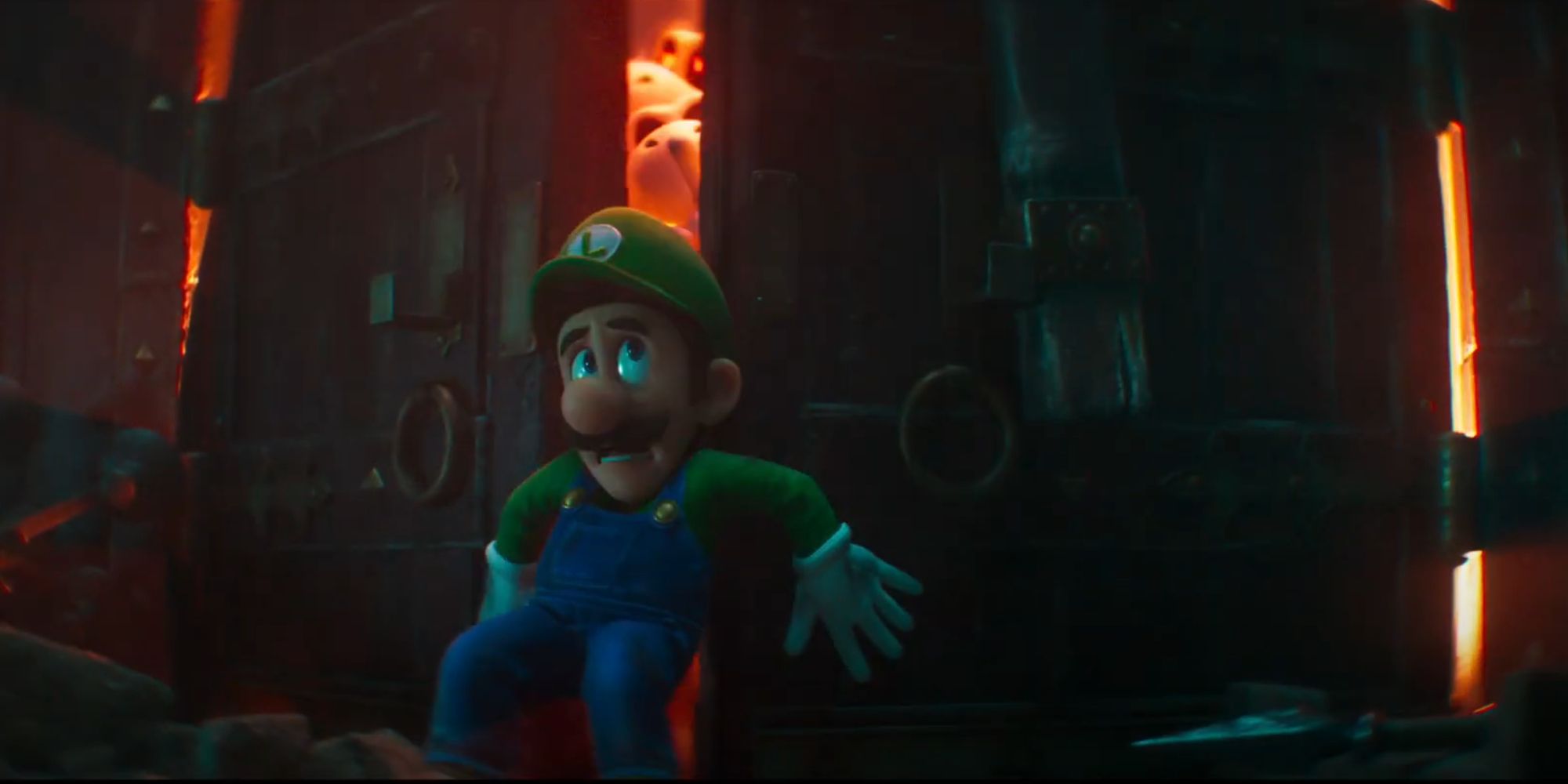 luigi trying to hold a castle door closed in the mario movie