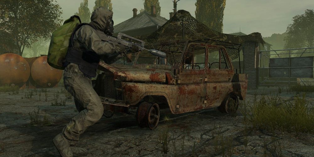 dayz charater in military gear running by rusted out car holding assault rifle
