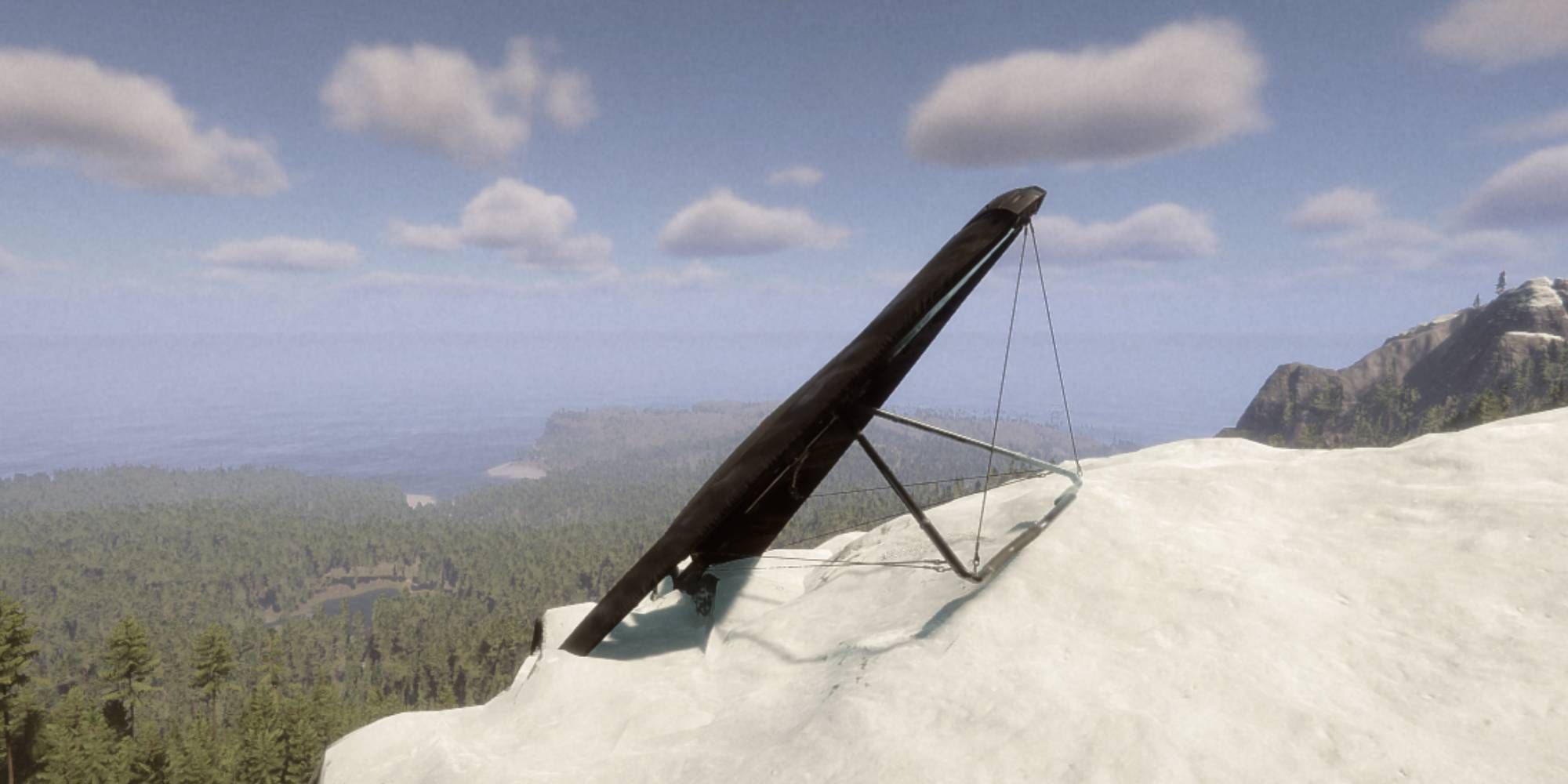 Hang Glider sitting on top of a snowy mountain by itself