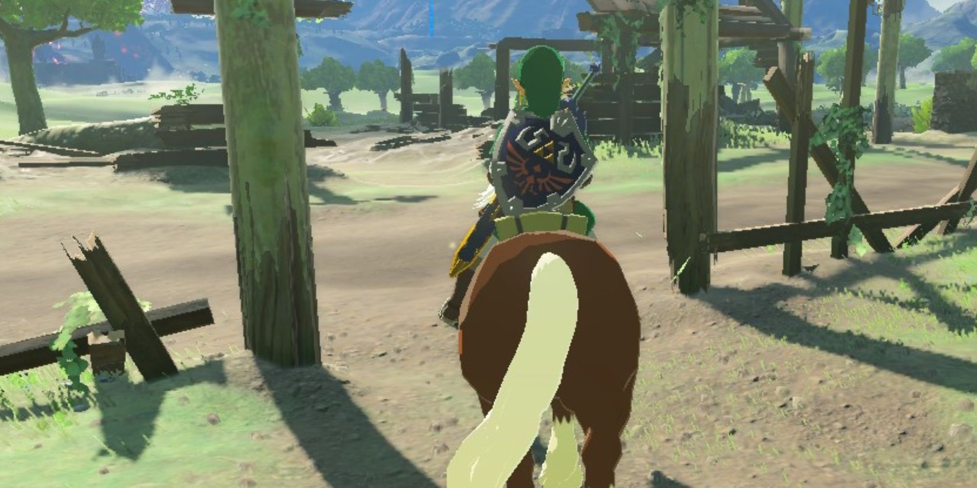 Link riding Epona through Ranch Ruins in BOTW
