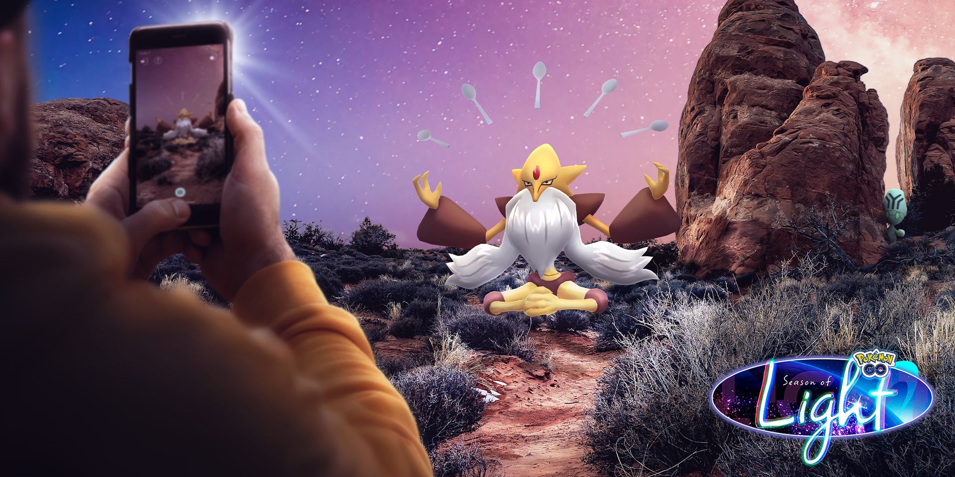Mega Alakazam with someone pointing their phone at it with an image of it on their screen