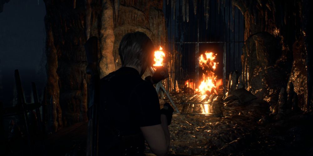 Leon Kennedy watches Ganado burn after shooting a Molotov cocktail in Resident Evil 4 Remake.