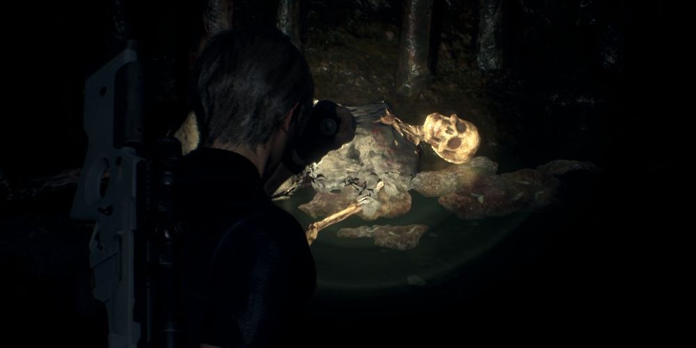 Leon Kennedy finds a skeleton in a cave beneath Castle Salazar in Resident Evil 4 Remake.