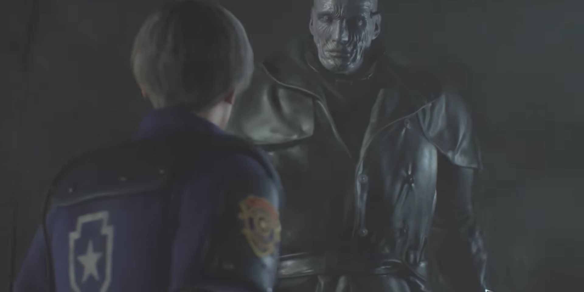 Leon staring up at a fiercely tall Mr. X without his hat in the garage, before Ada runs him over with a large vehicle.