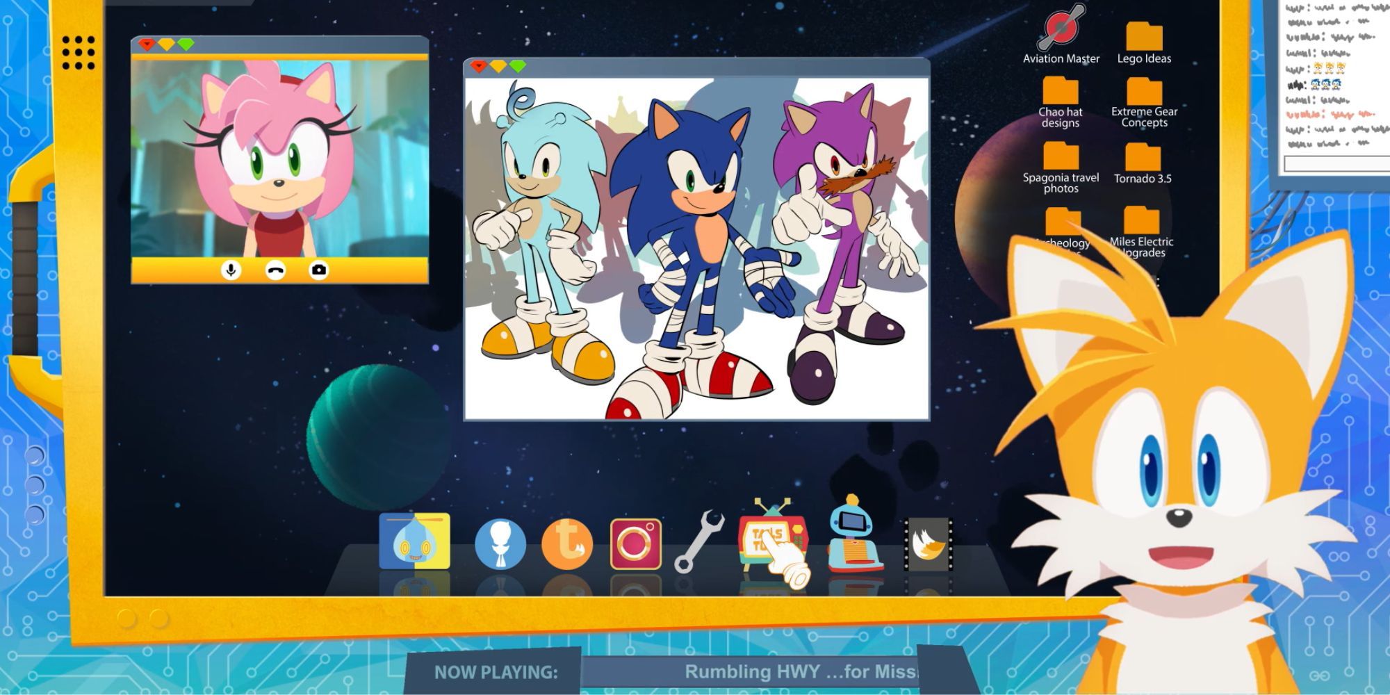 A screenshot of the latest episode of TailsTube. Showing Tails presenting the show, Amy co-hosting, and an image of multiple different coloured Sonics on the screen