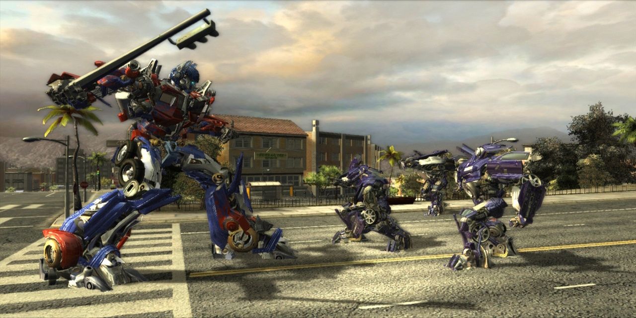 Optimus Prime fighting Decepticons with a traffic light in Transformers The Game