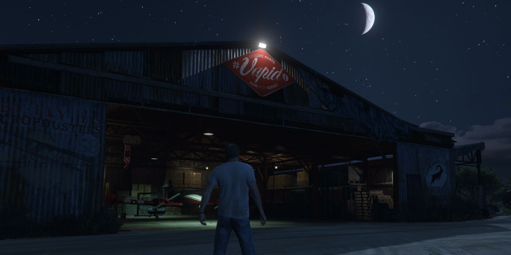 Trevor standing near McKenzie Field Hangar in Grand Theft Auto V