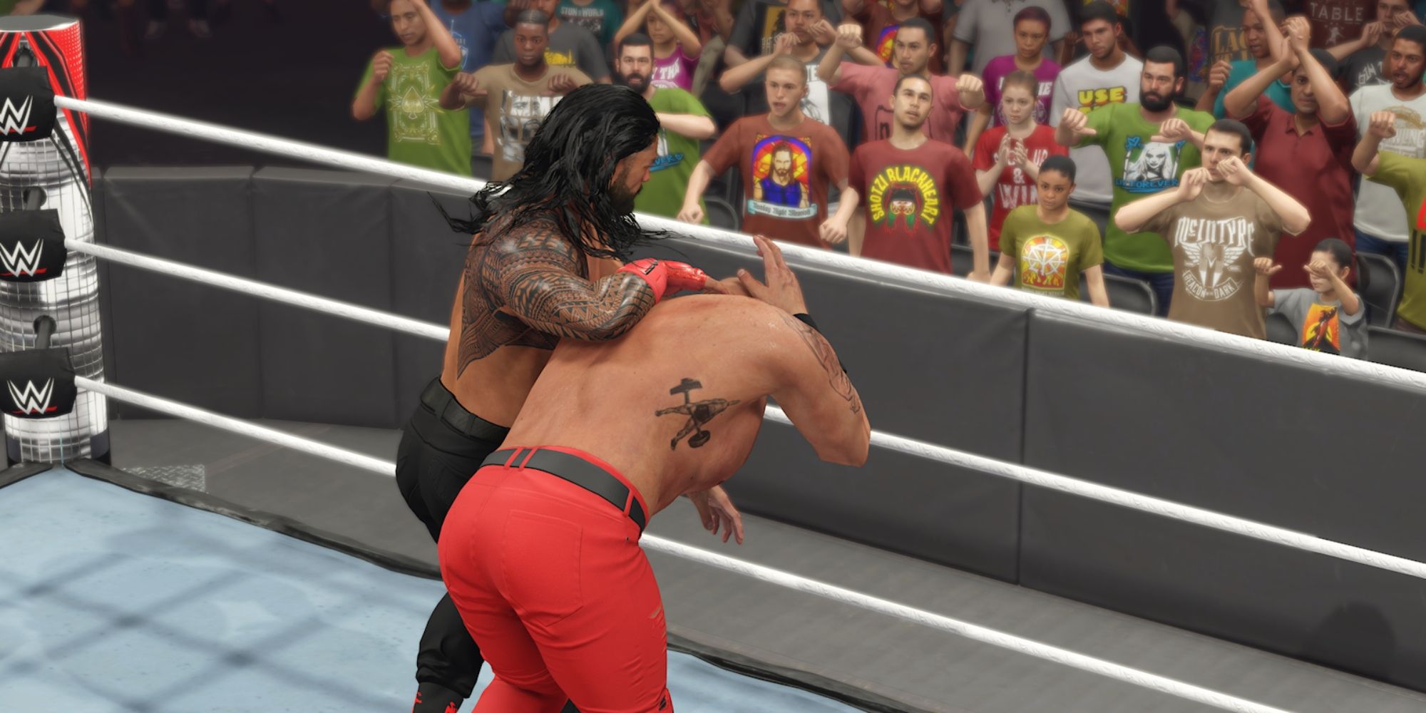 WWE 2K23 Screenshot Of Roman Reigns Dragging Strowman To The Ropes