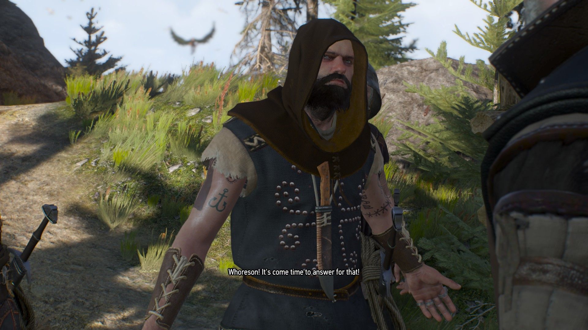 A hooded bandit shouts at Geralt as they speak on a hill in Skellige.