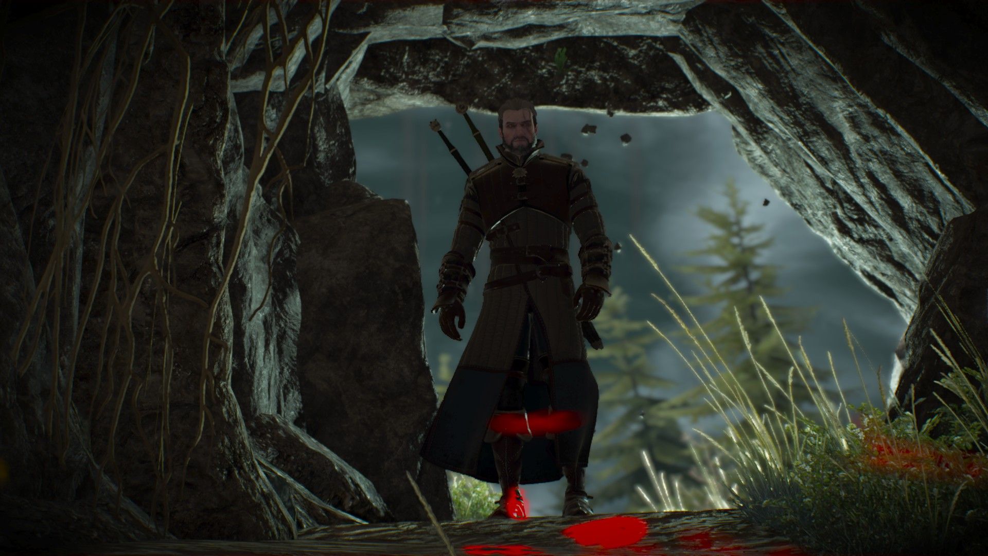 Geralt stands at the mouth of a cave in Skellige, with trees visible in the background, while a large rock falls behind him.