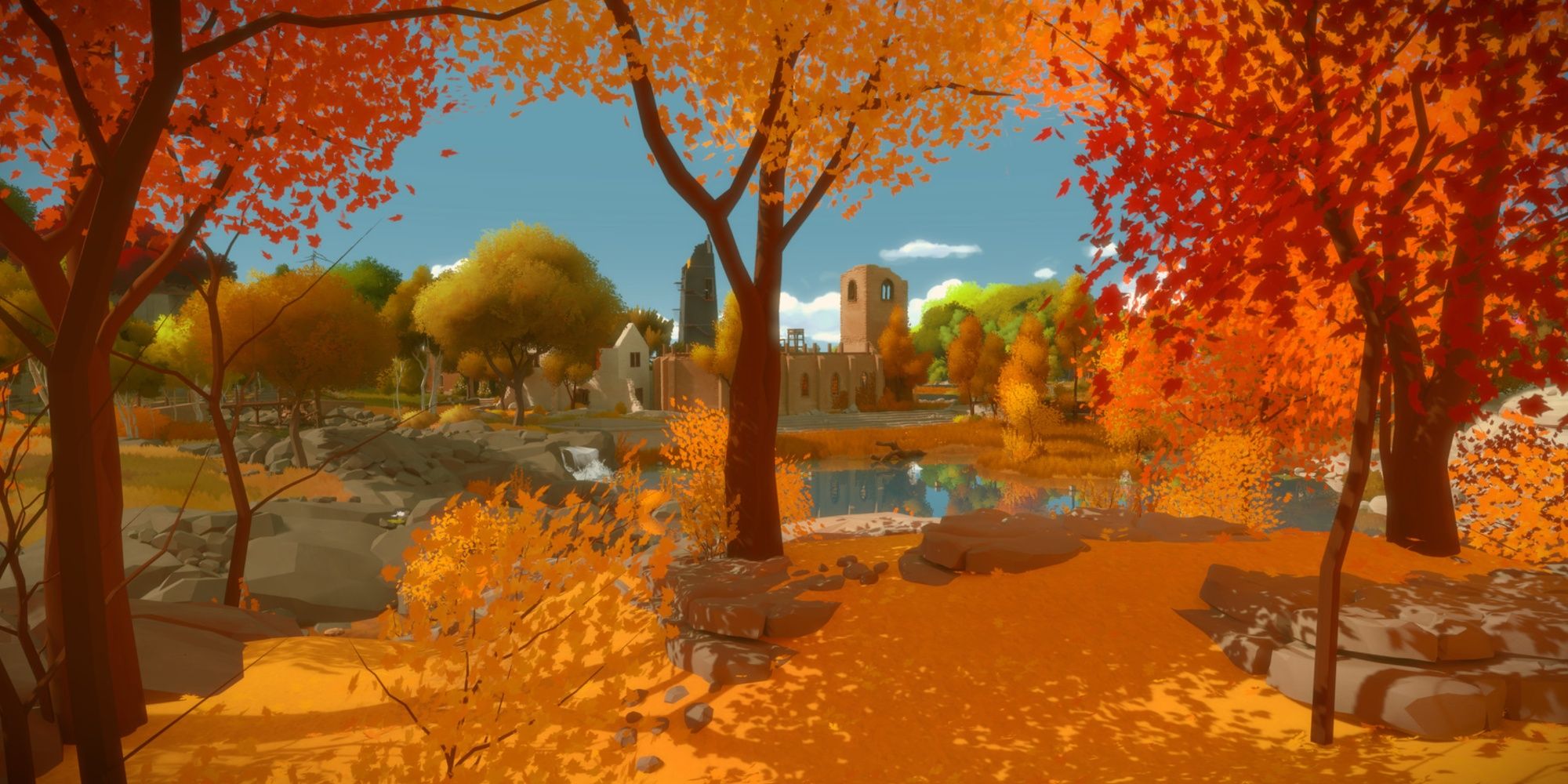 Autumnal trees and orange leaves covering the ground with a lake and a building in the background in The Witness