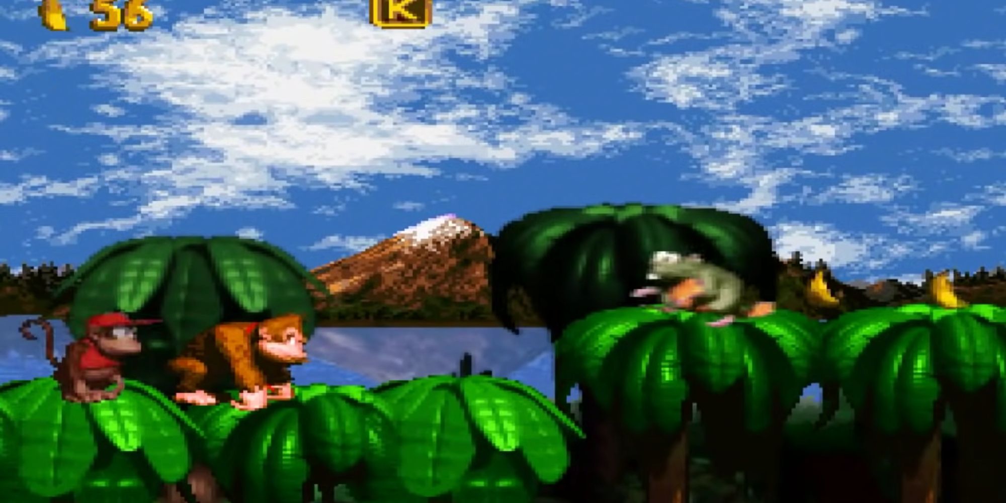 Donkey and Diddy Kong platforming atop tree canopies with an enemy and loose bananas in their path.