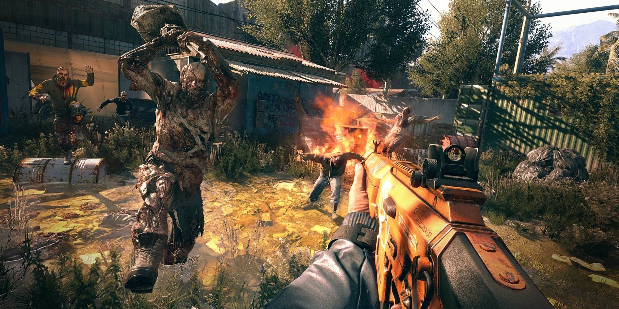 Zombies attacks a survivor who's holding an assault rifle in Dying Light