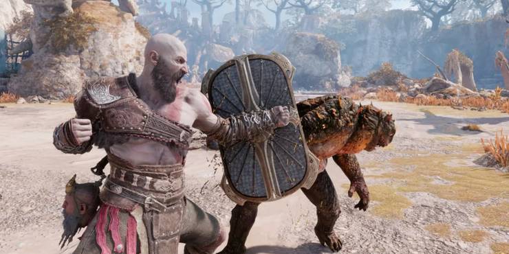 Kratos bashes a monster with a shield in God Of War Ragnarök.