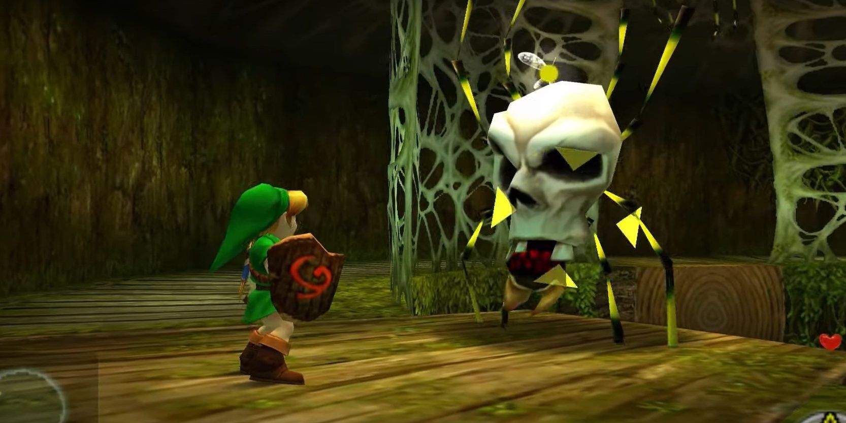 Link fighting a skultula in the Deku Tree in The Legend Of Zelda: Ocarina of Time