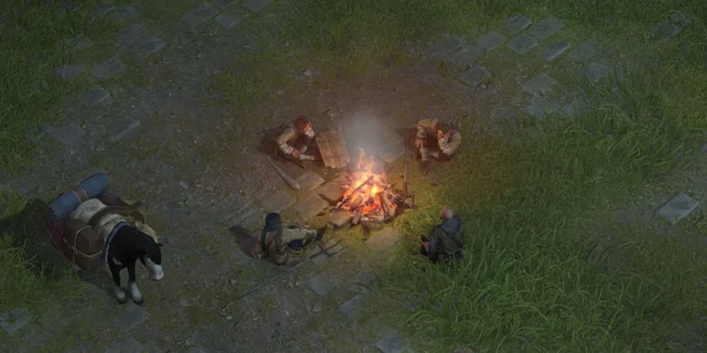 party sitting around campfire in wartales-1