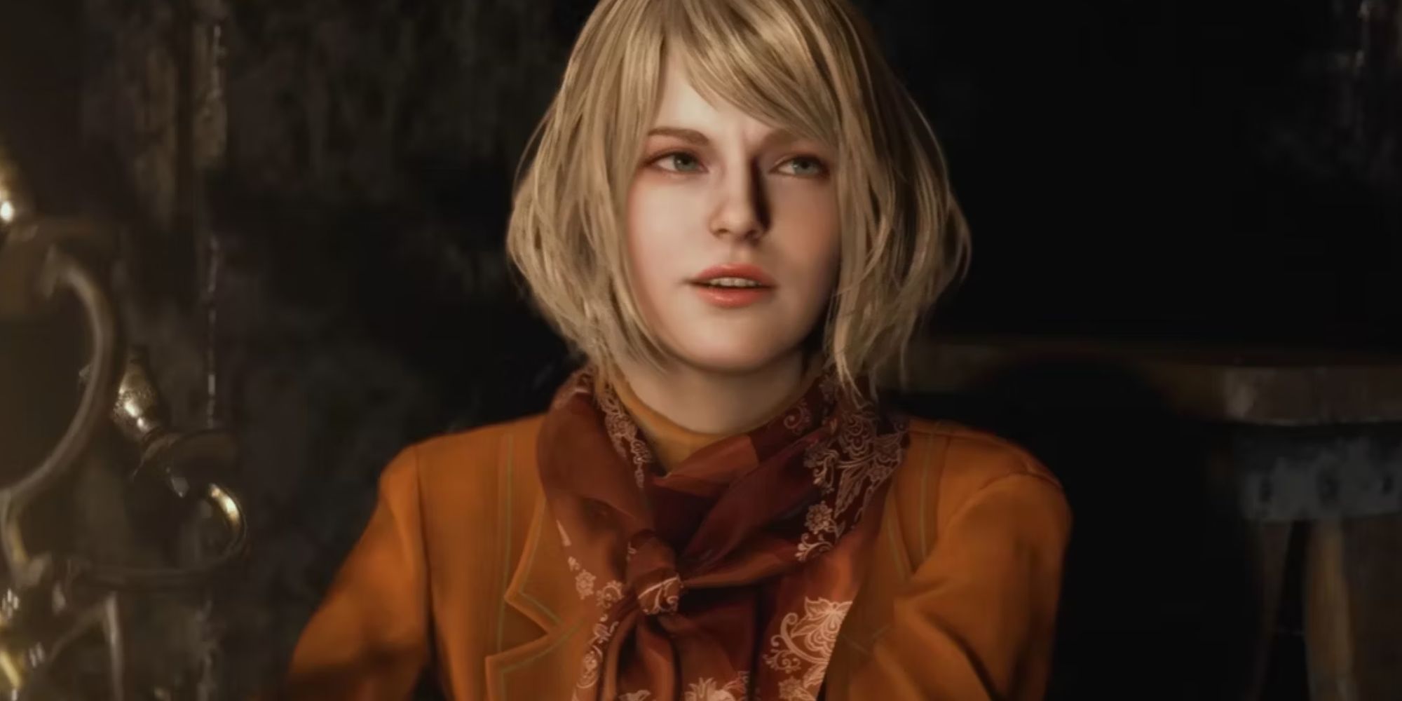 Ashley Graham in Resident Evil 4 Remake has long hair, an orange jacket and a red scarf. 