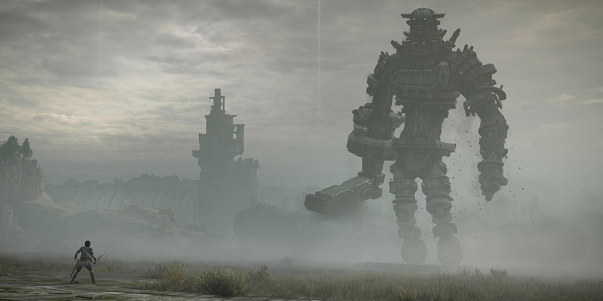 A male figure faces against a very tall stony figure in a fog ridden land