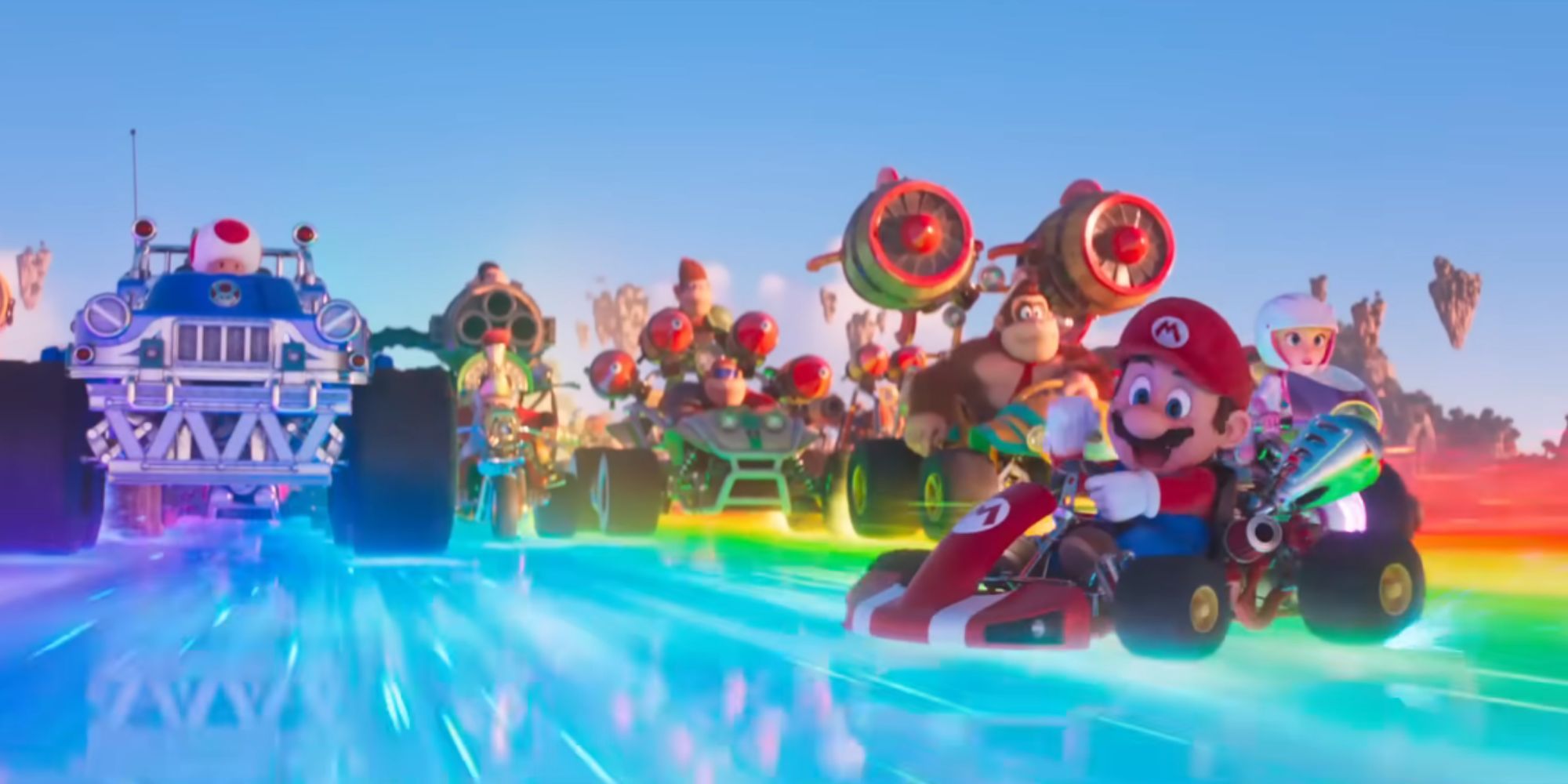 Mario drifts in his kart on Rainbow Road as other characters drive behind him