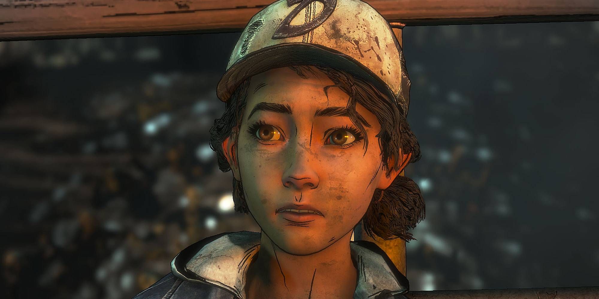 A tan young woman wearing a bloodied hat stares ahead