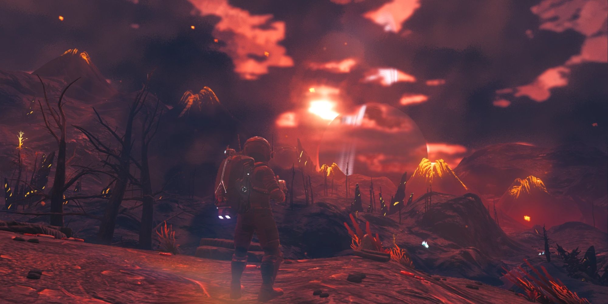 A photo of a Volcanic planet from No Man's Sky, featuring a red landscape with mountains that spew lava.