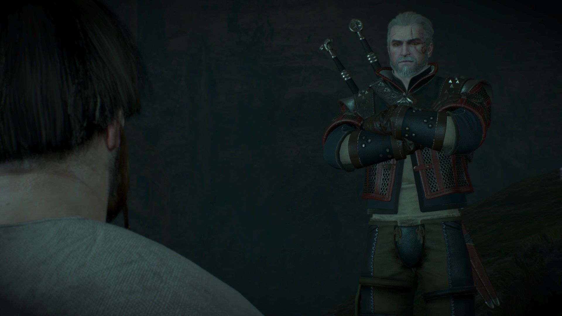 Geralt crosses his arms as he listens to a pair of survivors speak in a dark cave.