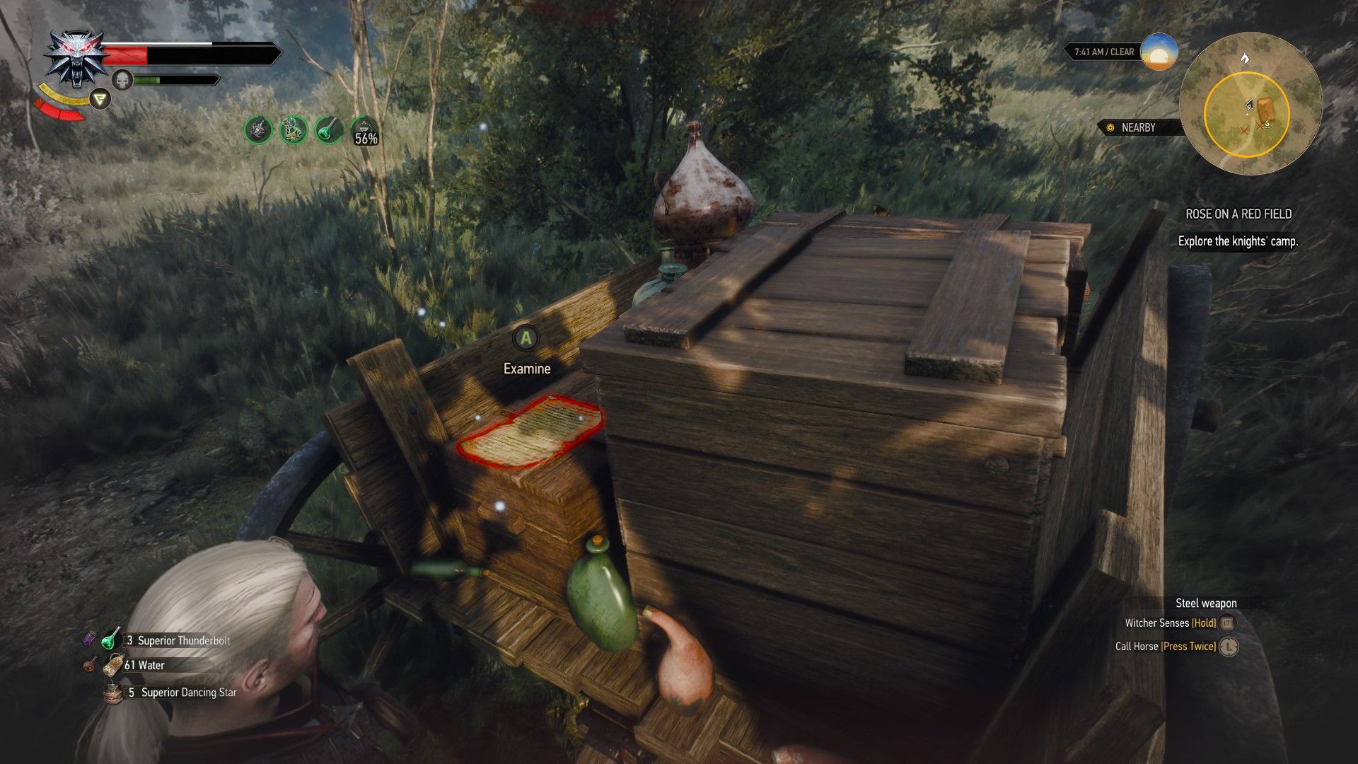 A screenshot of Geralt searching a wagon with a note highlighted by his Witcher Senses laid on a crate.