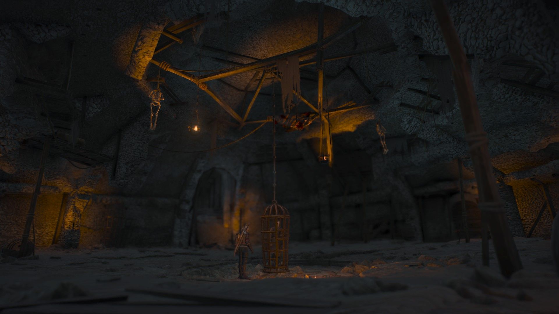 Geralt locks his friend in a cage in a cavernous room under the castle.