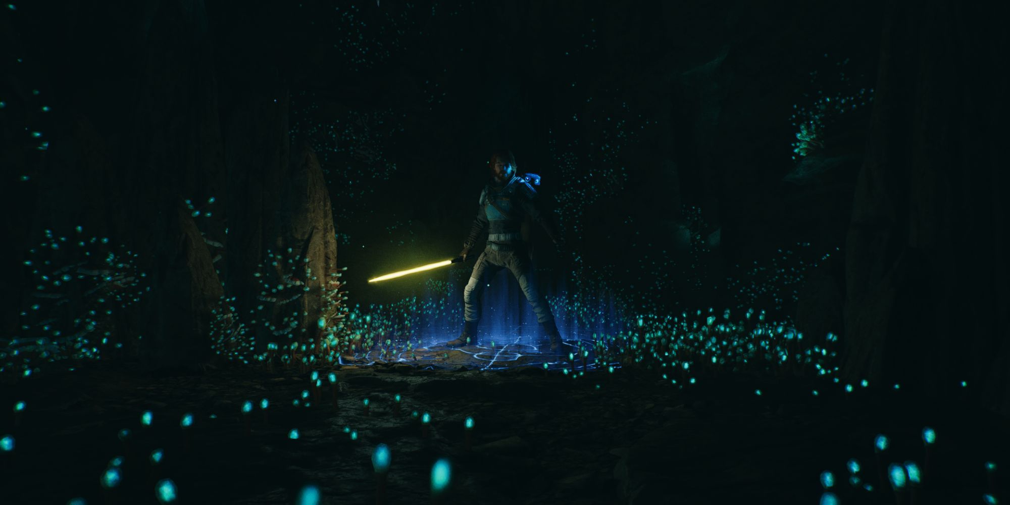Cal stands on a glowing meditation point in a cave while wielding his lightsaber