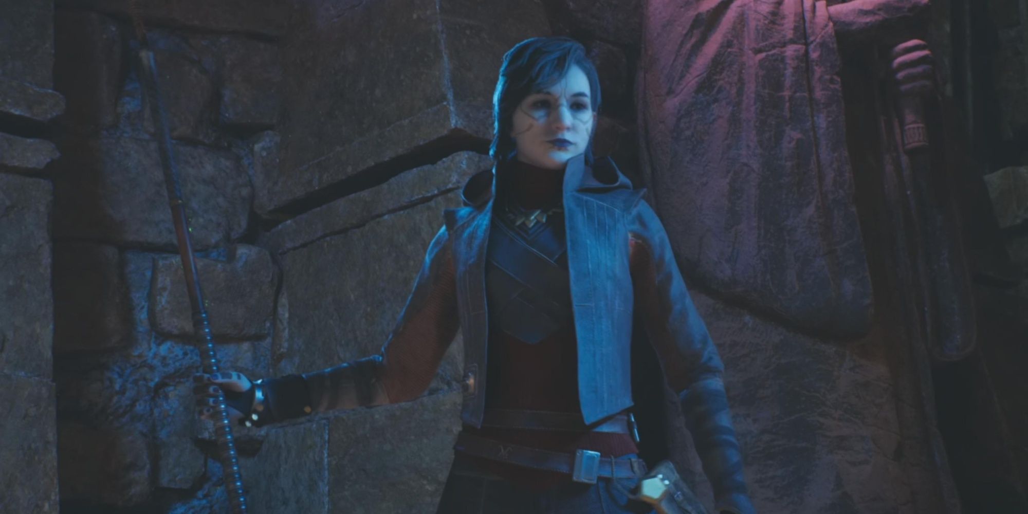 Merrin standing with her staff at the ready near a rocky landscape in the nighttime in Jedi: Survivor.