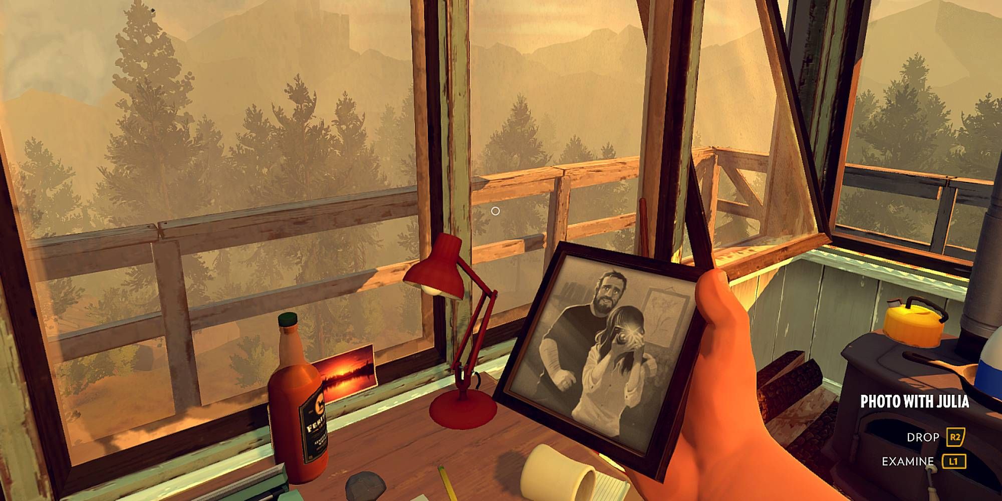 A figure holds a picture of a man and a woman in Firewatch.