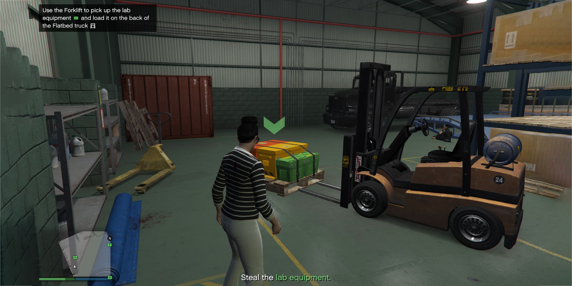 The image shows a Grand Theft Auto Online player standing in a warehouse next to a yellow forklift and equipment platform.  The palette has a green arrow pointing down at the top.