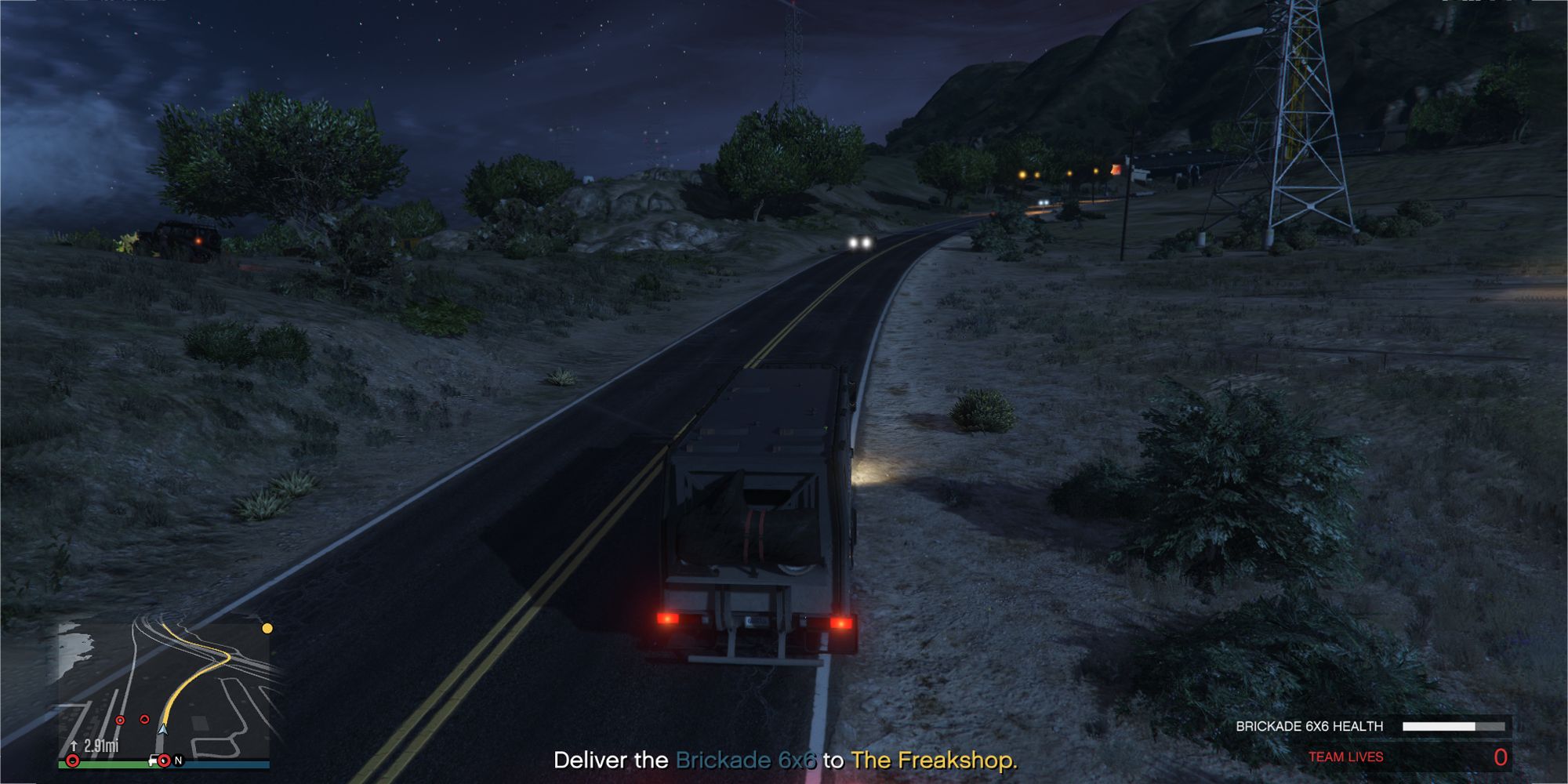 The image shows a Grand Theft Auto Online player delivering a 6x6 Brickade truck on the main road, surrounded by enemies.  The text in the bottom center reads 