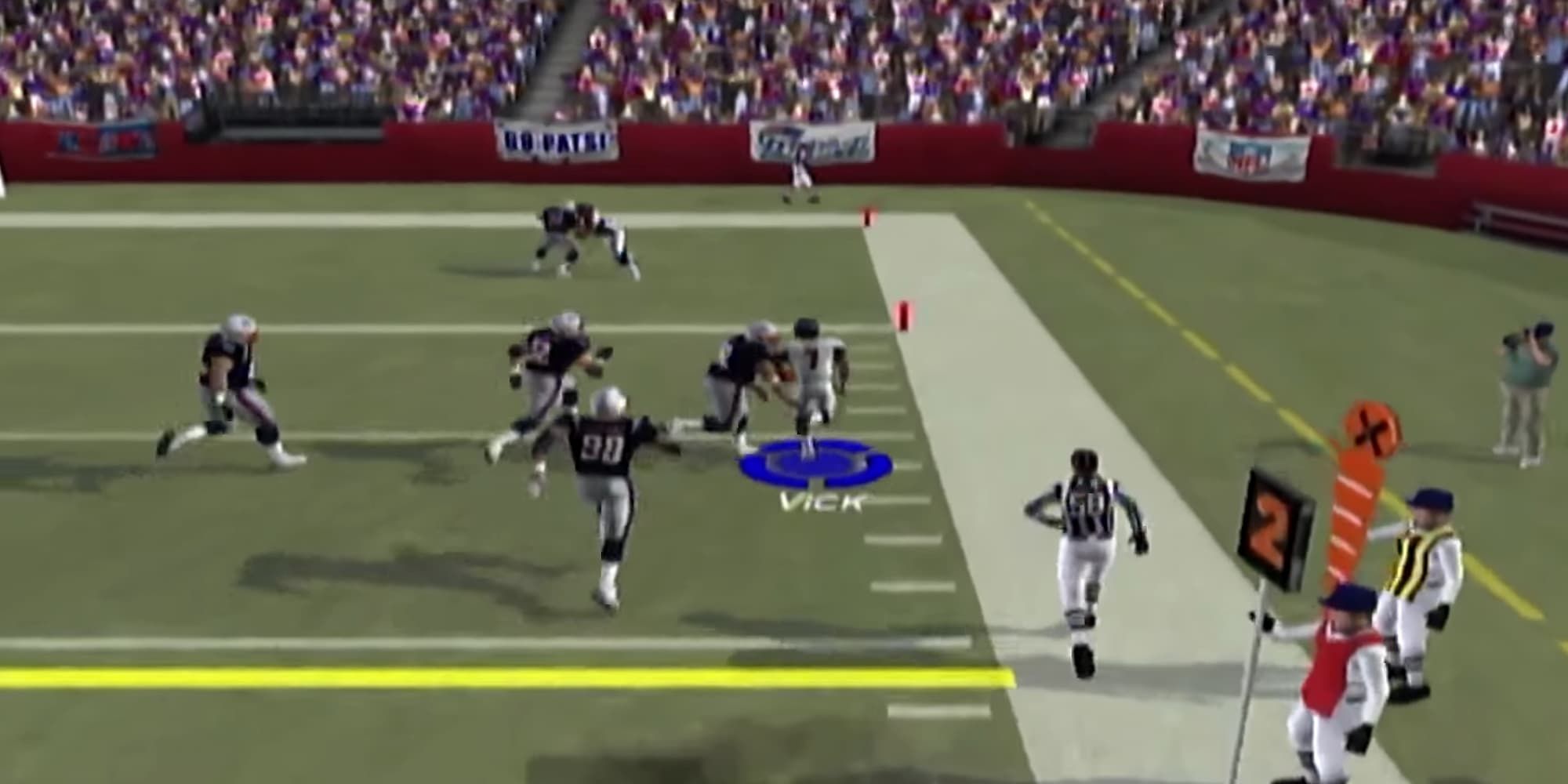 Michael Vick is being tackled by a New England Patriots player at Madden 2004.
