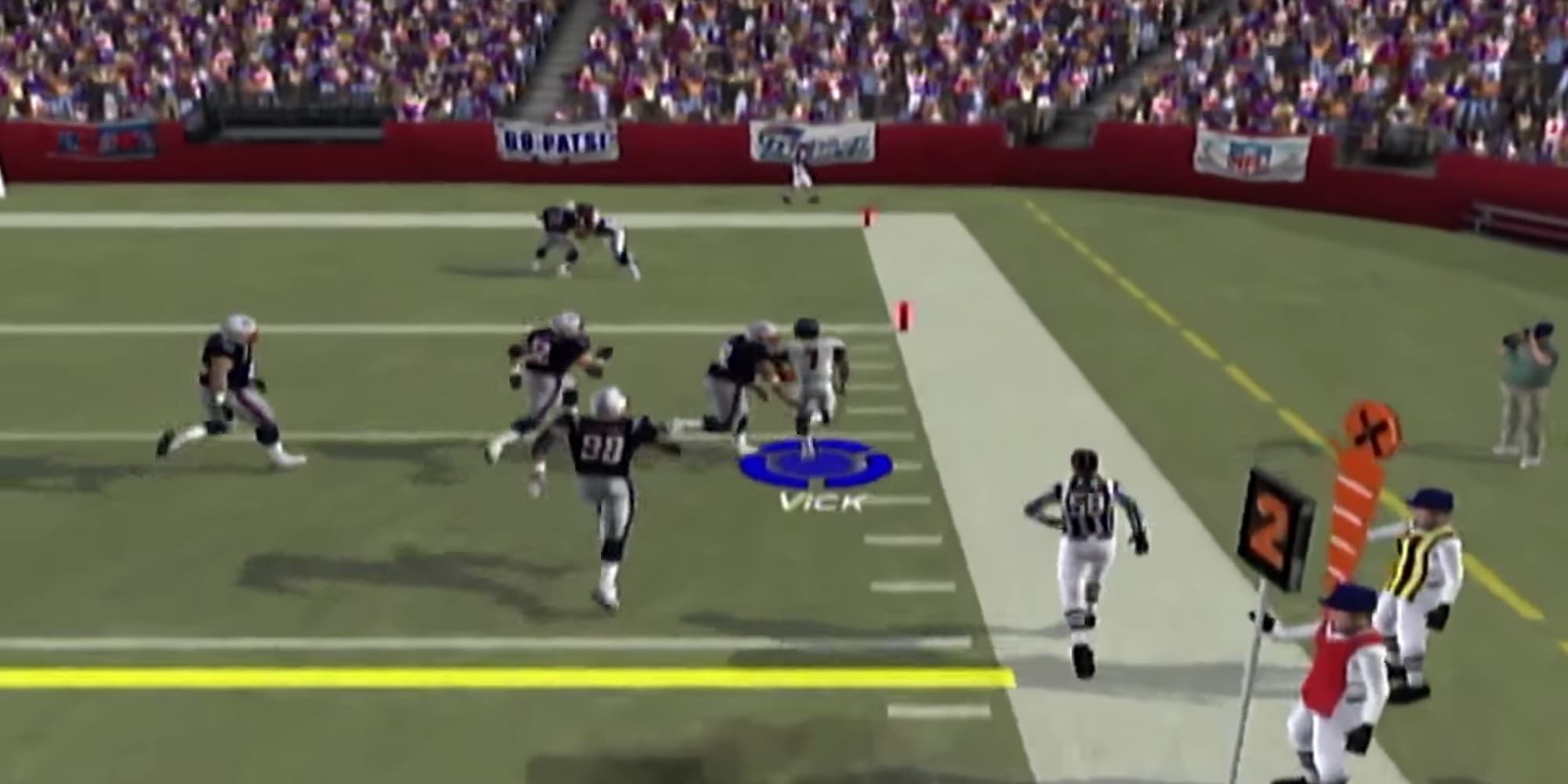 Michael Vick is being tackled by a New England Patriots player in Madden 2004.