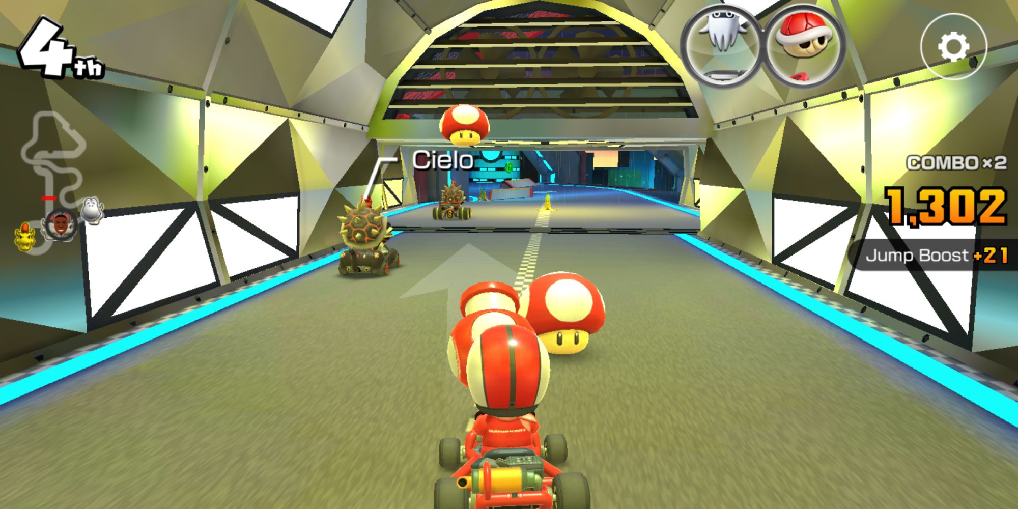 Mario Kart Tour intense multiplayer race with player at 4th position shooting a mushroom