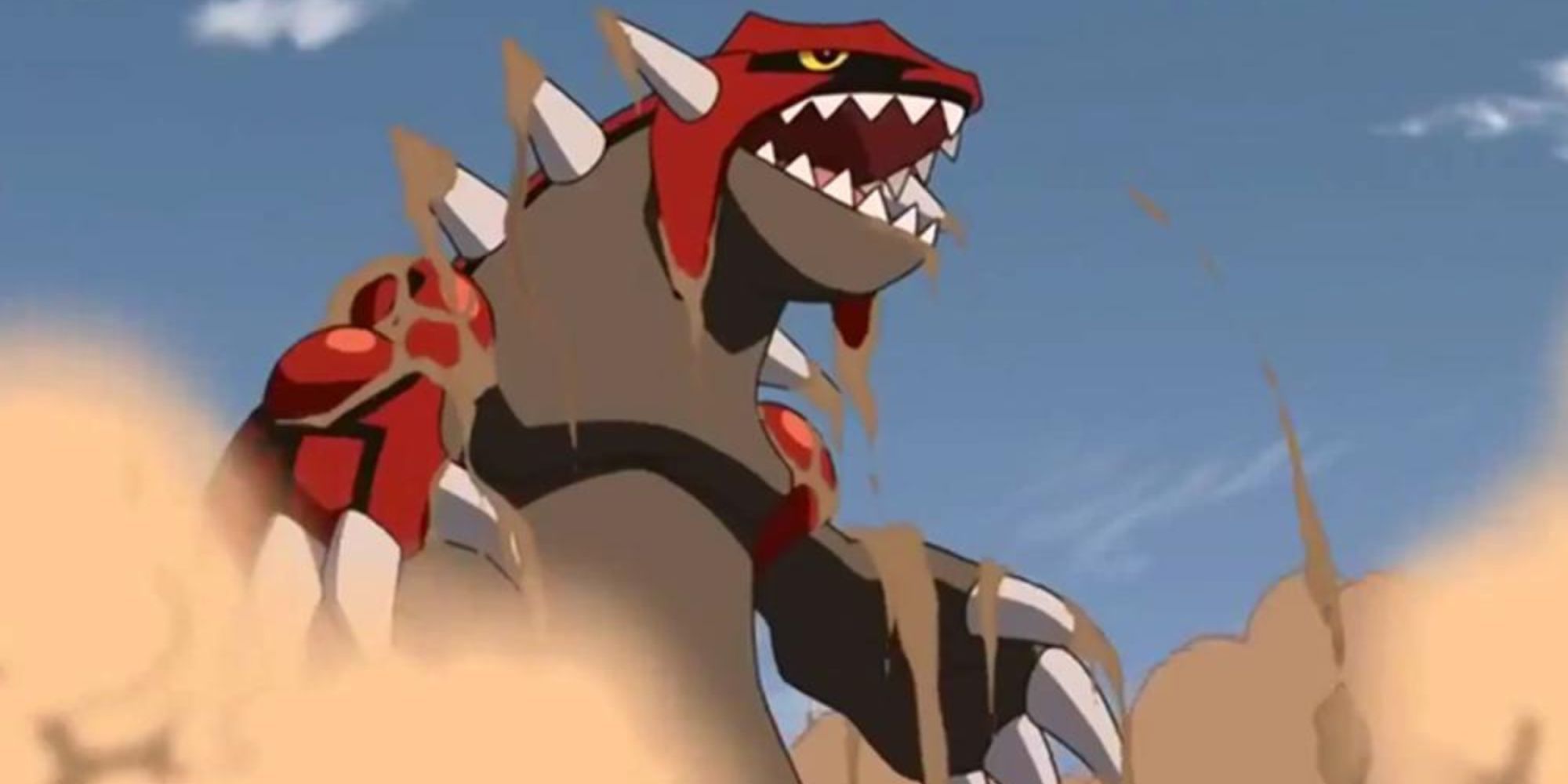 Groudon raises from the ground covered in sand