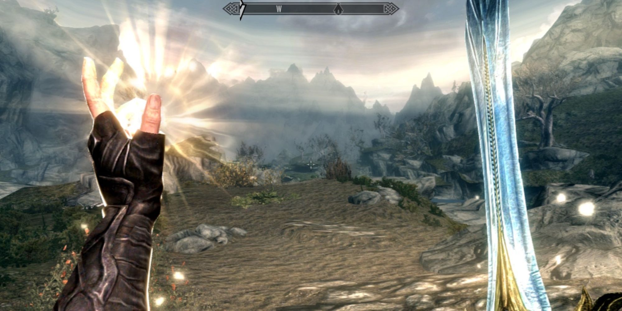 The player's left hand produces a light while his right hand carries a sword.